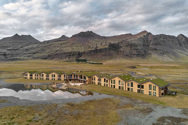 Modern hotel near mountainous landscape.