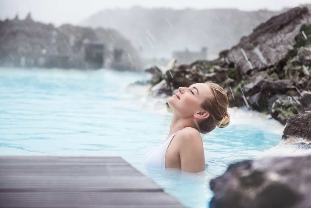 Woman relaxing in geothermal hot spring