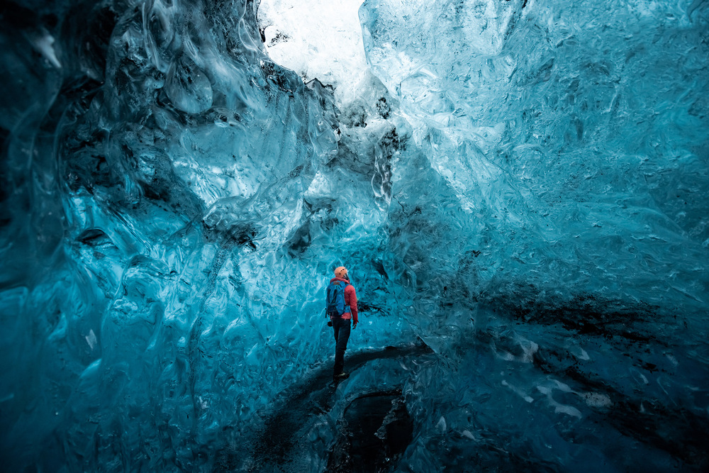 Person walking through an ice cave