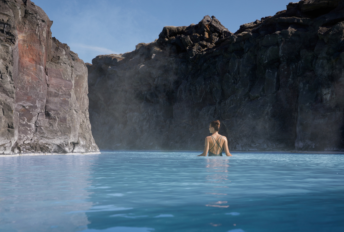 Person in serene blue geothermal water