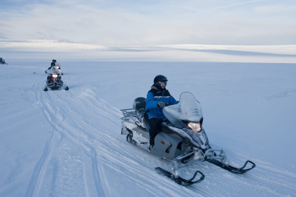 Two snowmobiles on snowy landscape