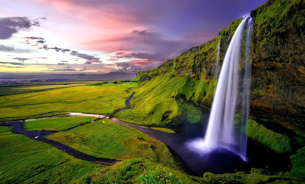 Seljalandsfoss waterfall under the midnight sun in southern Iceland.