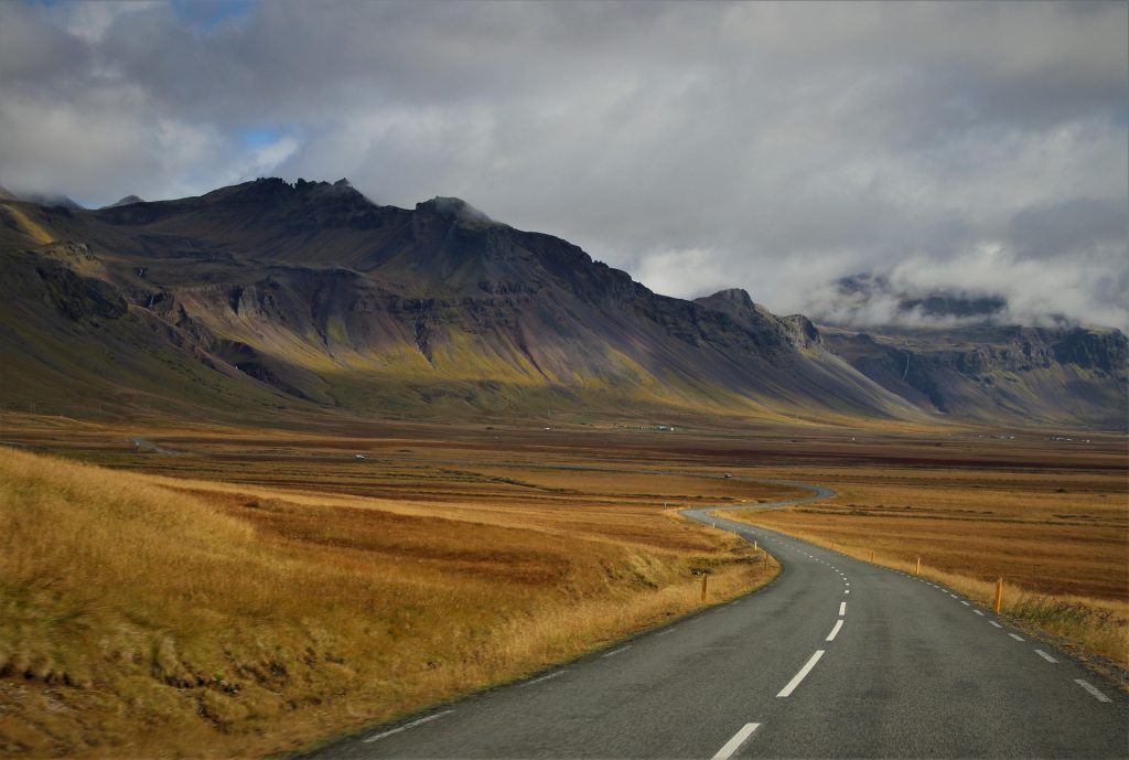 Scenic mountain road through an Icelandic valley for first-time visitors.