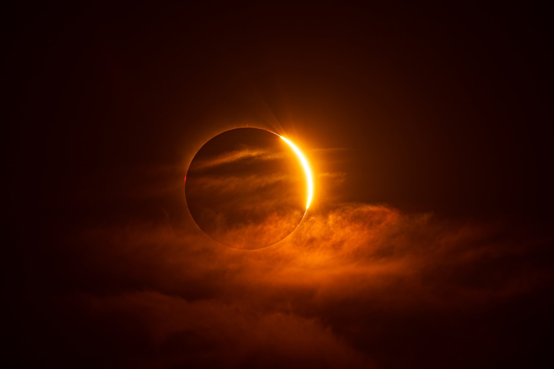 Partial solar eclipse behind clouds