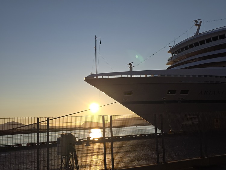 Cruise ship at sunset near dock