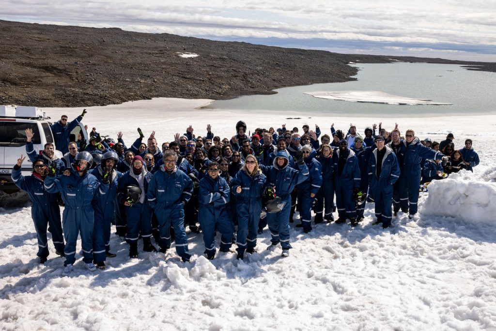 Incentive travel group wearing cold-weather gear on a glacier in Iceland.