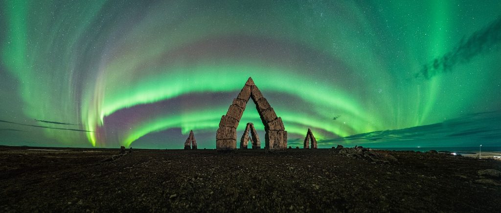 Green northern lights glow above the Arctic Henge in Raufarhöfn, Iceland.