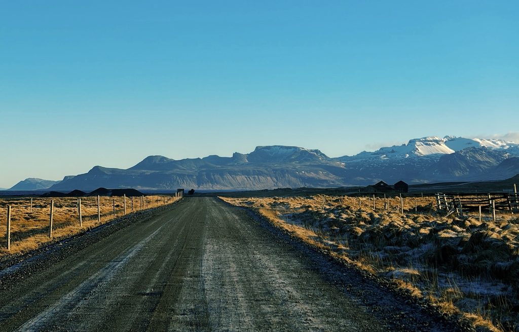 A road in Iceland - one of the safest countries in the world - with mountains in the back